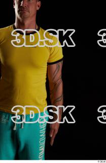 Arm flexing reference of body yellow shirt turquoise shorts brown…